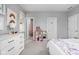 A cozy bedroom with neutral tones, carpet floors, a white dresser, a comfortable bed and access to a bathroom at 634 N Senate Ave, Indianapolis, IN 46202
