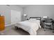 Bright bedroom with a bed, a desk, and closet with white doors for ample storage space at 634 N Senate Ave, Indianapolis, IN 46202