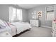 A cozy bedroom featuring neutral walls, carpet floors, soft lighting, a white dresser and a comfortable bed at 634 N Senate Ave, Indianapolis, IN 46202