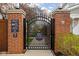 Private brick and iron gate entrance marked with security, enhancing the property's exclusivity at 634 N Senate Ave, Indianapolis, IN 46202