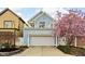 Beautiful curb appeal with a blooming tree, well-kept lawn and a charming blue exterior at 634 N Senate Ave, Indianapolis, IN 46202