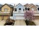Charming blue home with a lovely blooming tree, second story porch and well-manicured yard at 634 N Senate Ave, Indianapolis, IN 46202