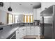 Bright kitchen boasts white cabinets, gray countertops, stainless steel appliances, and a bay window with yellow curtains at 634 N Senate Ave, Indianapolis, IN 46202