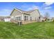 Spacious backyard featuring a lush green lawn and brick accents, perfect for outdoor activities at 639 Nuttal St, Westfield, IN 46074