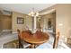 Inviting dining room featuring a wood table with seating, a chandelier, and a view into other living spaces at 639 Nuttal St, Westfield, IN 46074