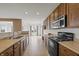Functional kitchen with ample counter space, wood cabinets, and modern black appliances at 639 Nuttal St, Westfield, IN 46074