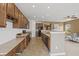 Spacious kitchen with wood cabinets, black appliances, and a convenient breakfast bar at 639 Nuttal St, Westfield, IN 46074