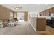 Spacious living room adjacent to kitchen featuring neutral carpet, a ceiling fan, and access to the sunroom at 639 Nuttal St, Westfield, IN 46074
