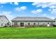 Expansive backyard with well-manicured lawn, patio, and charming exterior featuring a sliding glass door and brick accents at 661 Overcup St, Westfield, IN 46074