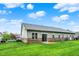 Spacious backyard features lush green grass and a patio with sliding glass doors, perfect for outdoor enjoyment at 661 Overcup St, Westfield, IN 46074