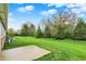 Lush backyard with green grass, and a concrete slab off the side of the home at 661 Overcup St, Westfield, IN 46074