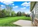 Large backyard with green grass and a concrete patio, great for outdoor entertaining at 661 Overcup St, Westfield, IN 46074