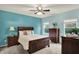 Cozy bedroom featuring wood furniture, a ceiling fan, and natural light from two windows at 661 Overcup St, Westfield, IN 46074