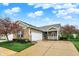 Charming single-story home with brick and siding, lush landscaping, and a well-manicured lawn at 661 Overcup St, Westfield, IN 46074