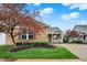 Beautiful brick home with mature trees and manicured landscaping, complemented by a welcoming front porch at 661 Overcup St, Westfield, IN 46074