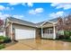 Spacious two-car garage with brick accents, complementing the home's exterior and well-kept landscaping at 661 Overcup St, Westfield, IN 46074