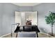 Home office with modern desk, comfortable chair, and view to living area through double doors at 661 Overcup St, Westfield, IN 46074