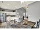 Well-lit kitchen featuring white cabinets, stainless steel appliances, and an adjacent dining area at 661 Overcup St, Westfield, IN 46074