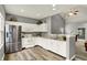 Bright kitchen with white cabinetry, stainless steel refrigerator, and eat-in breakfast bar at 661 Overcup St, Westfield, IN 46074