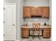 Office area with wooden cabinets, built-in desk, chair, and neutral walls at 661 Overcup St, Westfield, IN 46074