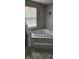 Corner bathtub with tile surround and tiled platform, and a window with blinds at 7497 Grandview Dr, Avon, IN 46123