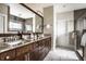 A modern bathroom boasts double sinks, granite countertops, and a tiled shower for a spa-like experience at 768 Trailside Dr, Carmel, IN 46032