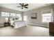 A serene bedroom features soft natural light, a ceiling fan, and neutral tones creating a calming retreat at 768 Trailside Dr, Carmel, IN 46032