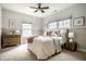Inviting bedroom showcasing a cozy bed, stylish furnishings, and natural light from multiple windows at 768 Trailside Dr, Carmel, IN 46032