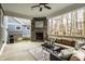 Inviting covered patio with a stone fireplace and comfortable wicker seating, great for relaxing outdoors at 768 Trailside Dr, Carmel, IN 46032