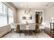 Stylish dining area with a light-filled windows and seating for six around an oval table at 768 Trailside Dr, Carmel, IN 46032