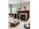 Close-up of the living room fireplace, with stone surround and custom wood mantel at 768 Trailside Dr, Carmel, IN 46032