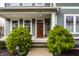 Inviting entryway with a wood door, manicured shrubs, and traditional architectural details at 768 Trailside Dr, Carmel, IN 46032