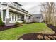Beautifully landscaped front yard with healthy green grass and verdant mulch beds with manicured shrubbery at 768 Trailside Dr, Carmel, IN 46032