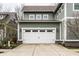 Two-car garage with a driveway, situated on a well-manicured lawn at 768 Trailside Dr, Carmel, IN 46032