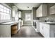 Well-lit laundry room with cabinetry, countertop space, modern appliances, and tile flooring at 768 Trailside Dr, Carmel, IN 46032