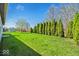Spacious backyard with lush green grass and mature trees, offering plenty of space for outdoor enjoyment at 7854 Crooked Meadows Dr, Indianapolis, IN 46268