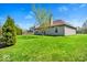Spacious backyard featuring a lush green lawn and mature trees, ideal for outdoor activities at 7854 Crooked Meadows Dr, Indianapolis, IN 46268