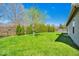 A lush backyard with a well-manicured lawn and mature trees, perfect for outdoor enjoyment at 7854 Crooked Meadows Dr, Indianapolis, IN 46268