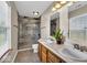 Bathroom featuring double sinks, tile floors, and tile-surround walk-in shower at 7854 Crooked Meadows Dr, Indianapolis, IN 46268