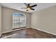 Well-lit bedroom boasts a ceiling fan, neutral walls, and unique tiled flooring at 7854 Crooked Meadows Dr, Indianapolis, IN 46268