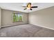 Large bedroom featuring a ceiling fan, a window, and carpeted floors at 7854 Crooked Meadows Dr, Indianapolis, IN 46268