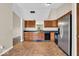 Well-lit kitchen with stainless steel refrigerator and a view of the backyard at 7854 Crooked Meadows Dr, Indianapolis, IN 46268