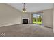 Bright living room with fireplace and sliding glass doors offering a view of the backyard at 7854 Crooked Meadows Dr, Indianapolis, IN 46268
