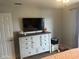 Bright bedroom featuring a TV on the dresser, closet, and natural light at 7916 Begonia Ct, Indianapolis, IN 46113