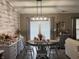 Charming dining room with wood-look accent wall, pendant lighting, and gray wood chairs at 7916 Begonia Ct, Indianapolis, IN 46113