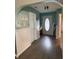 Inviting entryway featuring arched doorways, wainscoting, and a stylish front door with decorative glass at 7916 Begonia Ct, Indianapolis, IN 46113