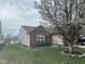 Attractive single-story home with lush lawn and beautiful flowering tree gracing the front yard at 7916 Begonia Ct, Indianapolis, IN 46113