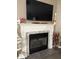Elegant fireplace with black firebox, white mantel, and tile surround at 7916 Begonia Ct, Indianapolis, IN 46113