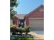 Charming brick home featuring a decorative front door and well-maintained landscaping, creating inviting curb appeal at 7916 Begonia Ct, Indianapolis, IN 46113