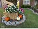 Landscaped front yard with colorful flowers and pumpkins at 7916 Begonia Ct, Indianapolis, IN 46113